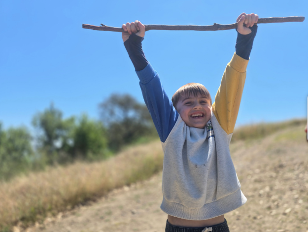 excited blue oak school student in nature